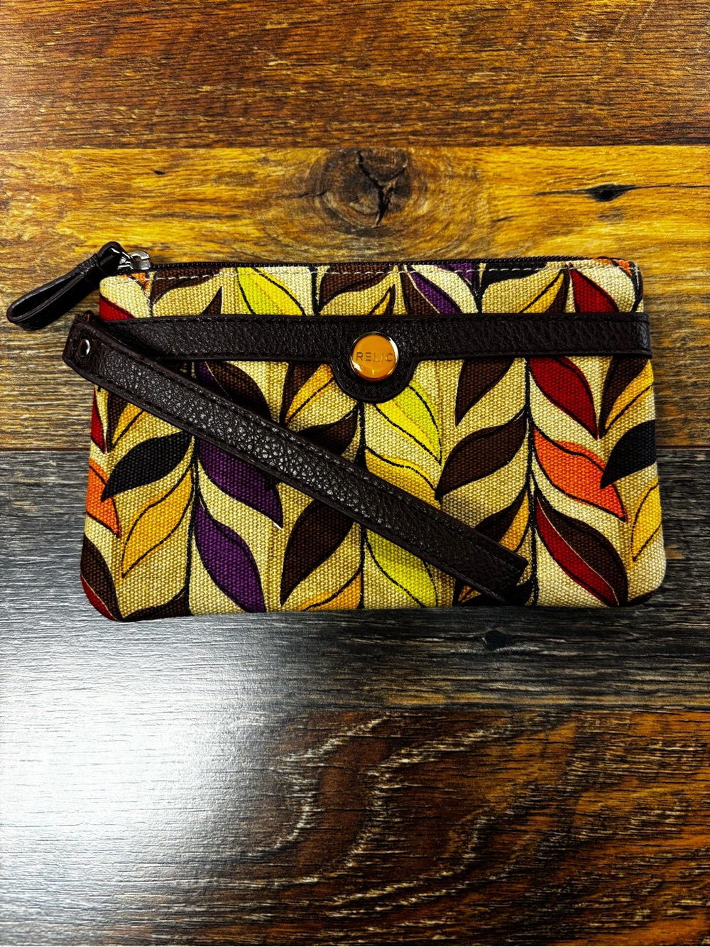 Relic wristlet colorful leaf-patterned canvas, vegan brown leather trim.